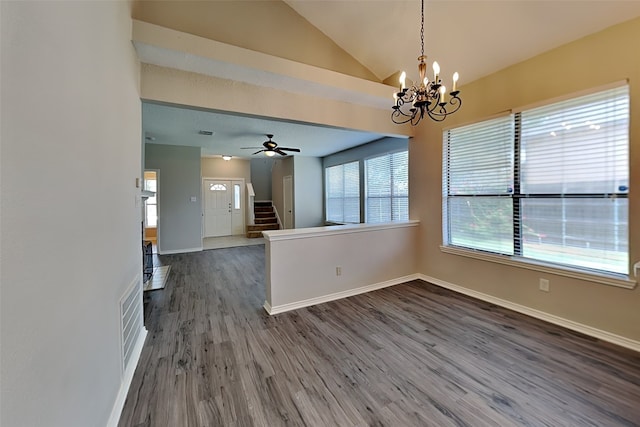 spare room with ceiling fan with notable chandelier, hardwood / wood-style floors, and lofted ceiling