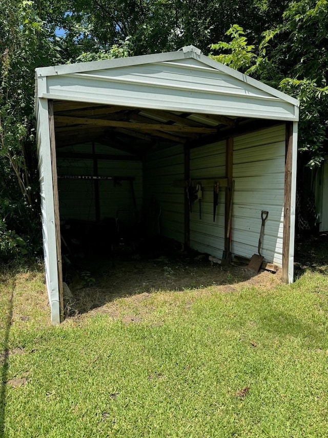 view of outbuilding featuring a lawn