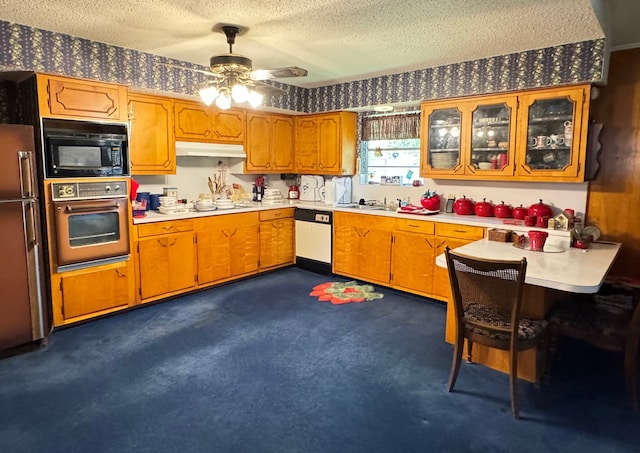 kitchen featuring refrigerator, oven, white dishwasher, black microwave, and a textured ceiling