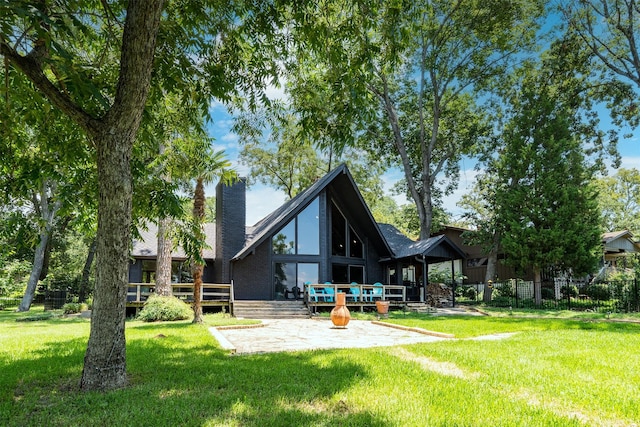 back of house with a patio area and a yard