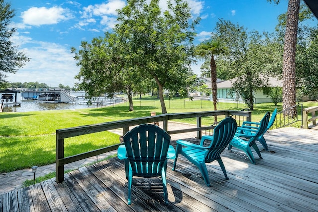 deck with a water view and a yard