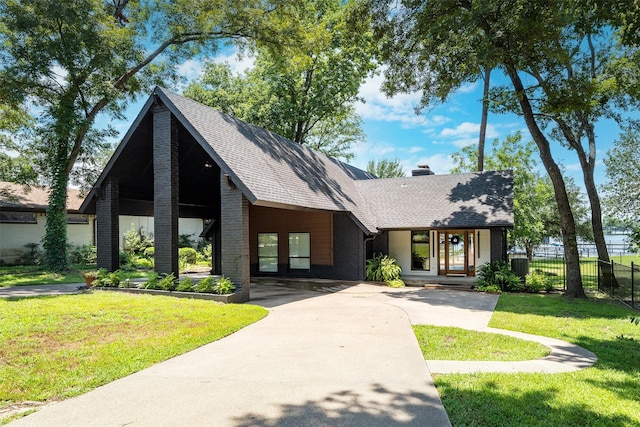 view of front of property with a front yard and french doors