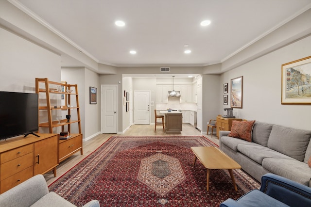 living room featuring light hardwood / wood-style floors and ornamental molding