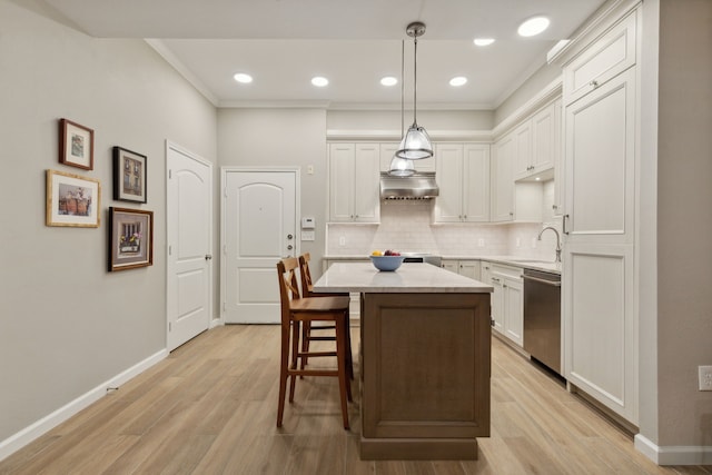 kitchen featuring a center island, white cabinetry, sink, hanging light fixtures, and stainless steel dishwasher