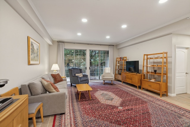 living room with crown molding and hardwood / wood-style floors