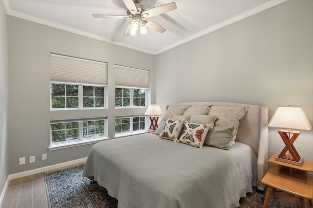 bedroom featuring ceiling fan, hardwood / wood-style floors, and ornamental molding