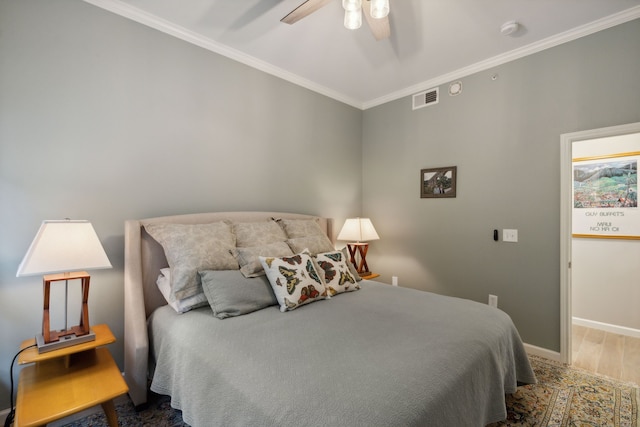 bedroom with ceiling fan, crown molding, and hardwood / wood-style floors