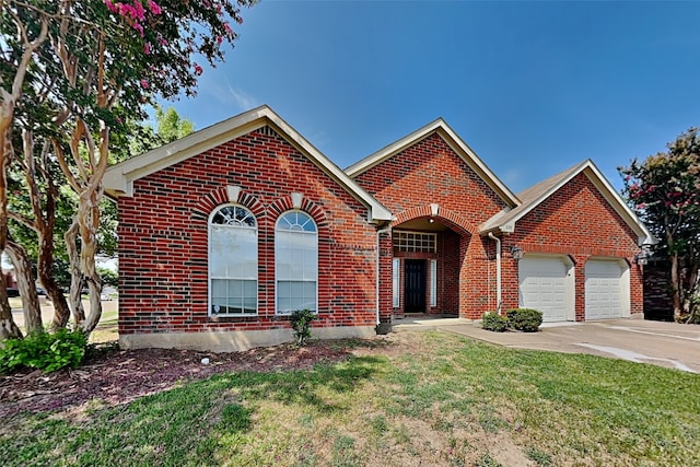 view of front of property with a front yard and a garage