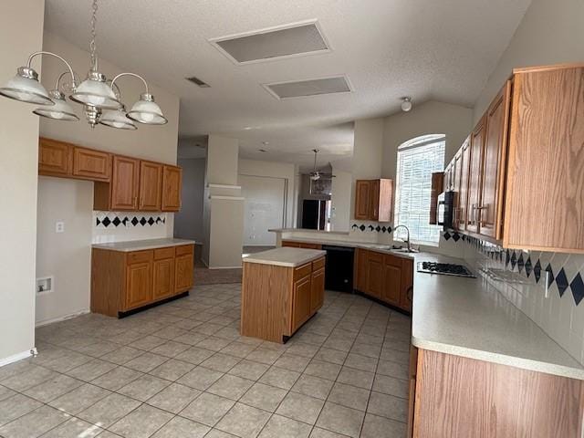 kitchen with pendant lighting, a center island, sink, and tasteful backsplash