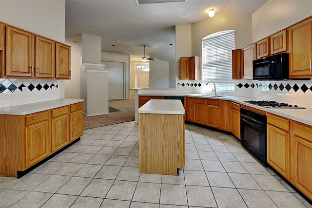 kitchen with sink, a kitchen island, black appliances, light tile patterned flooring, and kitchen peninsula