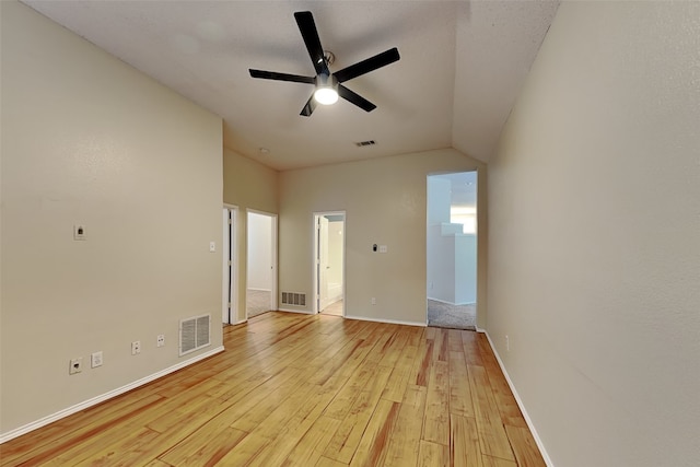 unfurnished room with ceiling fan, light wood-type flooring, and lofted ceiling