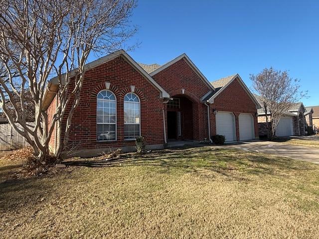 view of front of house featuring a garage and a front lawn