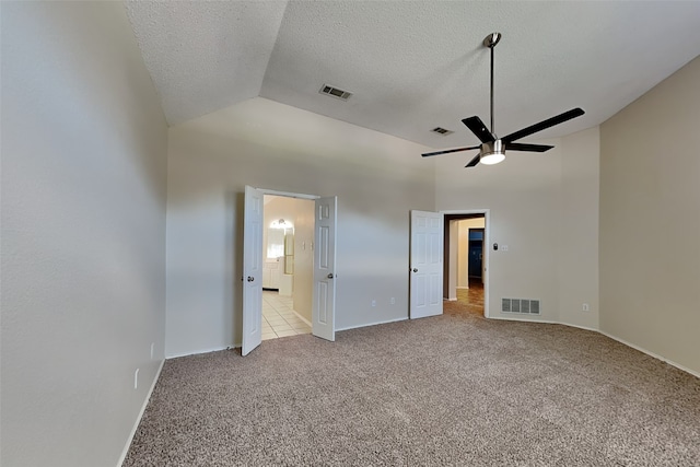 unfurnished bedroom with ensuite bathroom, high vaulted ceiling, ceiling fan, light carpet, and a textured ceiling