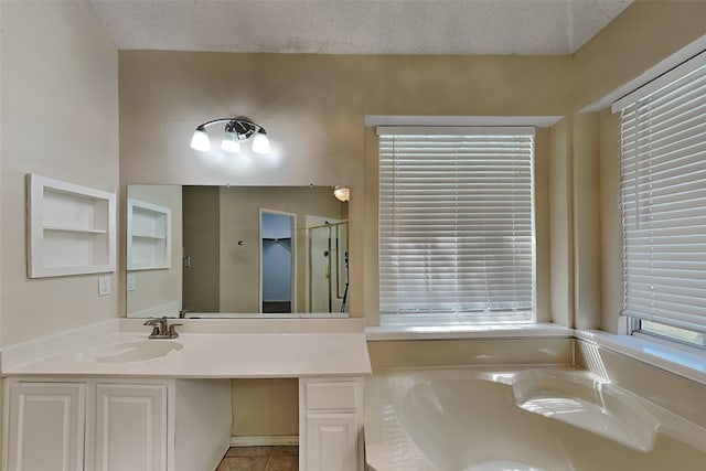 bathroom with sink, a bath, and a textured ceiling