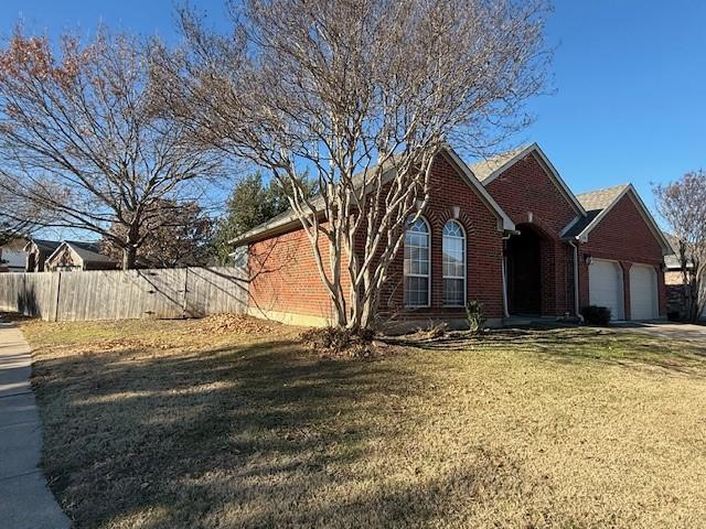 view of front facade with a garage and a front lawn