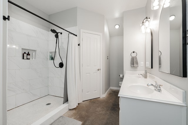 bathroom with concrete floors, a shower with curtain, and vanity