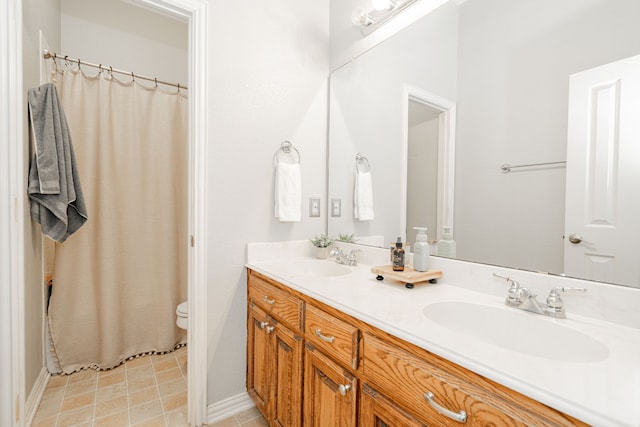 bathroom featuring toilet and vanity