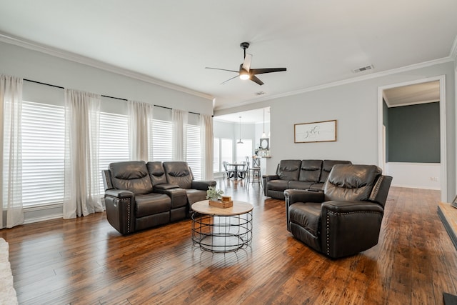 living room featuring ceiling fan, dark hardwood / wood-style floors, a wealth of natural light, and crown molding