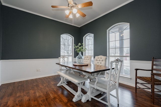 dining space with ornamental molding and dark hardwood / wood-style floors