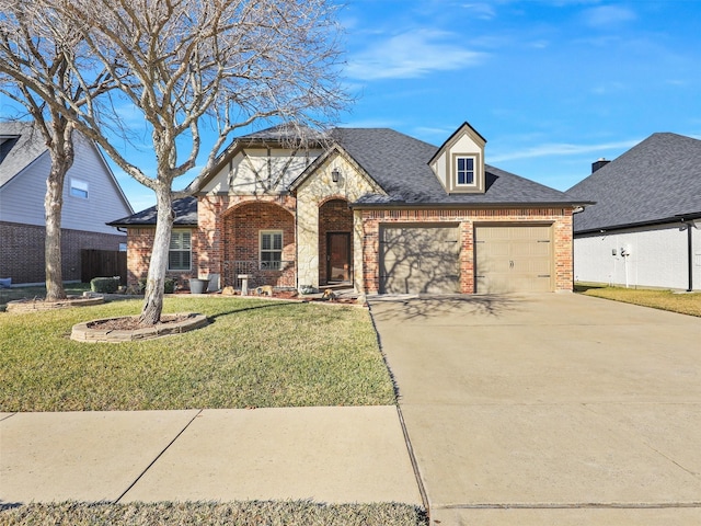 view of front of property with a garage and a front lawn