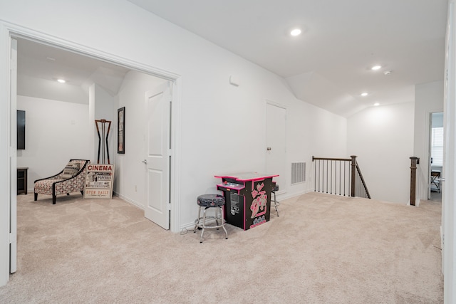 interior space featuring lofted ceiling and light colored carpet