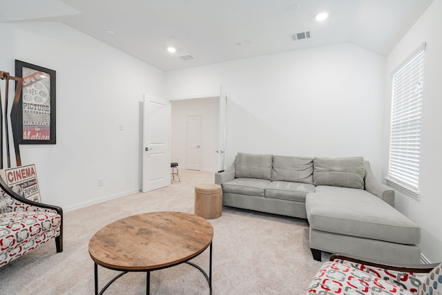 carpeted living room with lofted ceiling