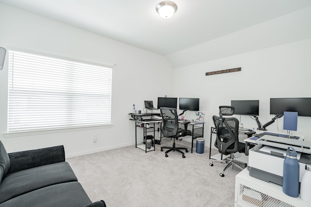 office area with lofted ceiling and light colored carpet