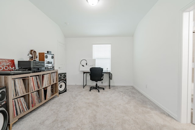 office featuring lofted ceiling and light carpet