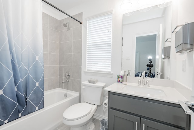 full bathroom featuring vanity, shower / bath combo, and toilet