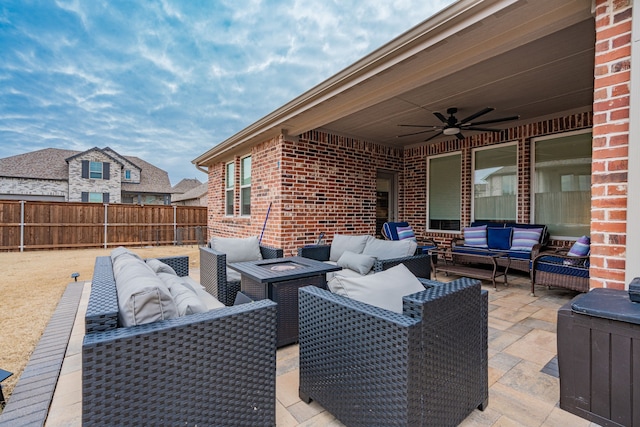 view of patio / terrace with an outdoor living space with a fire pit and ceiling fan