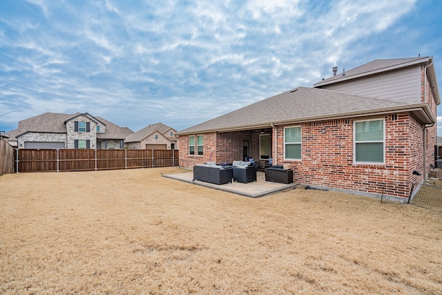 rear view of house featuring an outdoor living space, a yard, and a patio