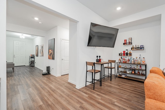 living room featuring hardwood / wood-style flooring and bar