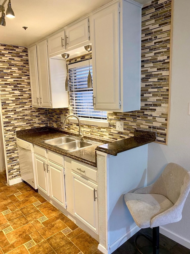 kitchen with sink, white cabinets, dishwasher, and tasteful backsplash