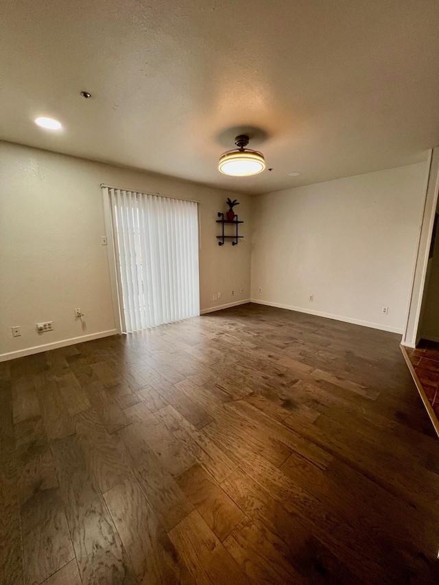 empty room featuring dark hardwood / wood-style flooring