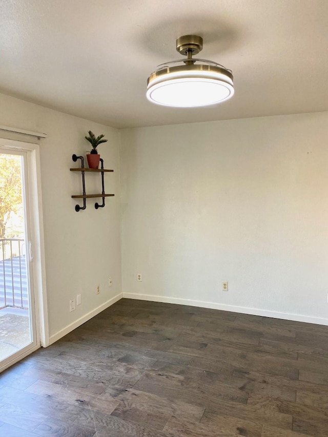 spare room featuring dark wood-type flooring