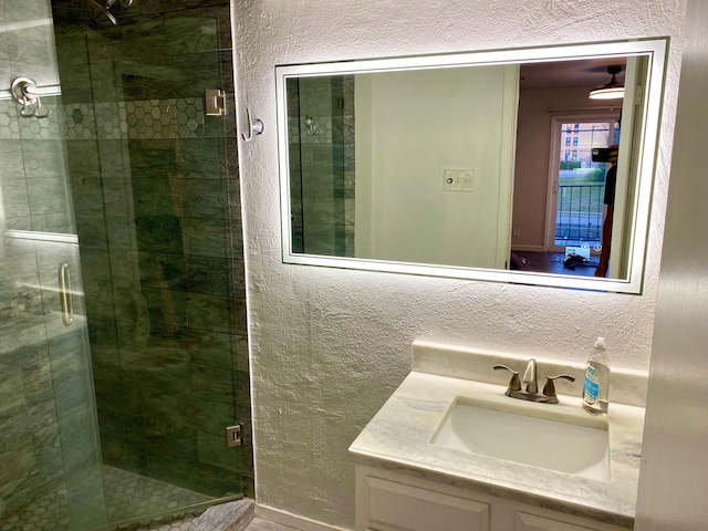 bathroom featuring an enclosed shower and vanity