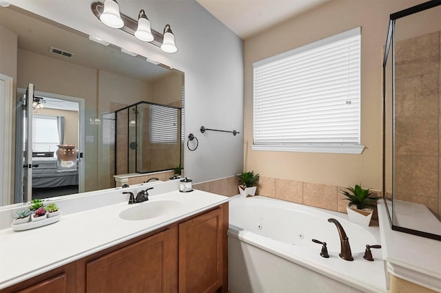 bathroom featuring vanity and shower with separate bathtub