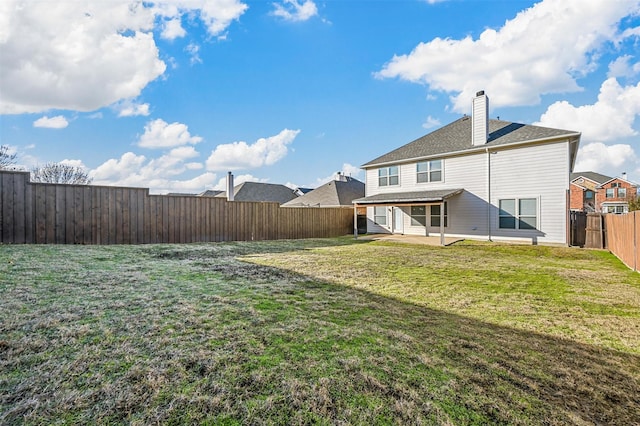 back of property featuring a patio and a yard