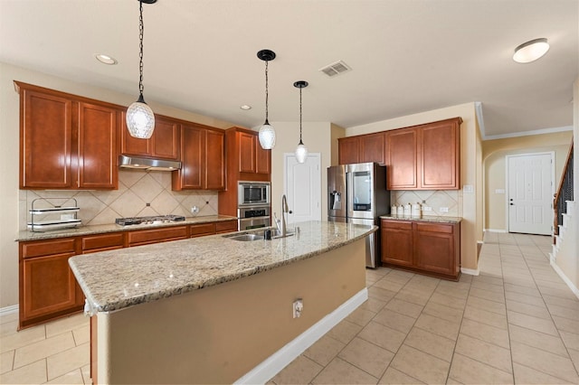 kitchen with light tile patterned floors, a kitchen island with sink, stainless steel appliances, and pendant lighting