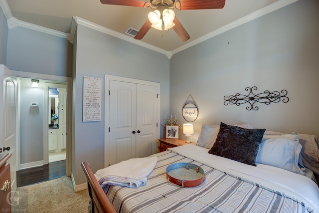 bedroom featuring ceiling fan, a closet, dark carpet, and ornamental molding