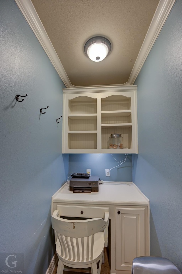 home office with a textured ceiling and ornamental molding