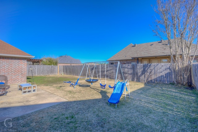 view of jungle gym with a yard and a patio