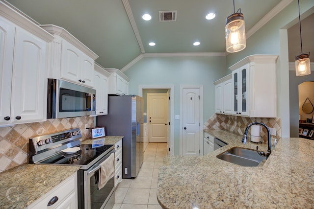 kitchen featuring hanging light fixtures, white cabinets, sink, and stainless steel appliances