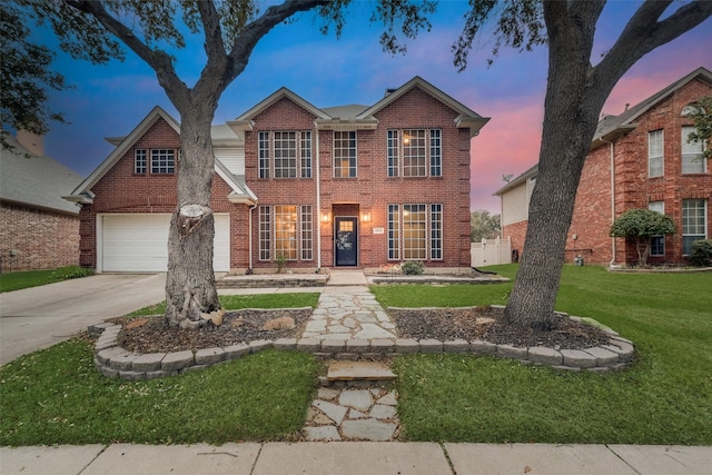 view of front facade with a lawn and a garage