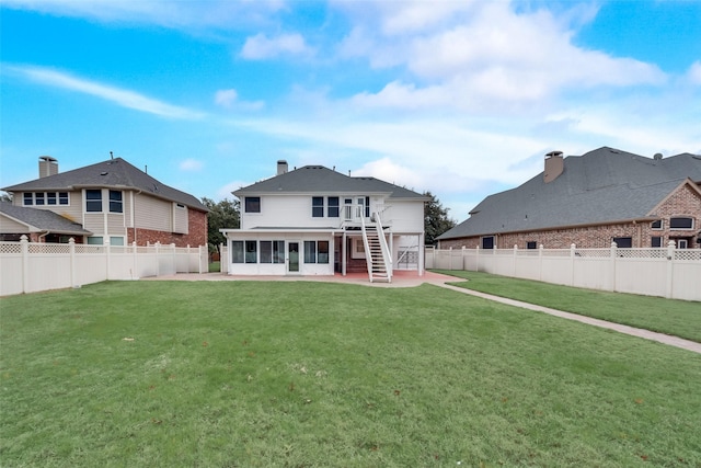 rear view of house featuring a lawn and a patio