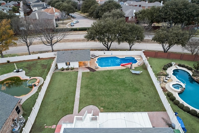 view of pool with a lawn