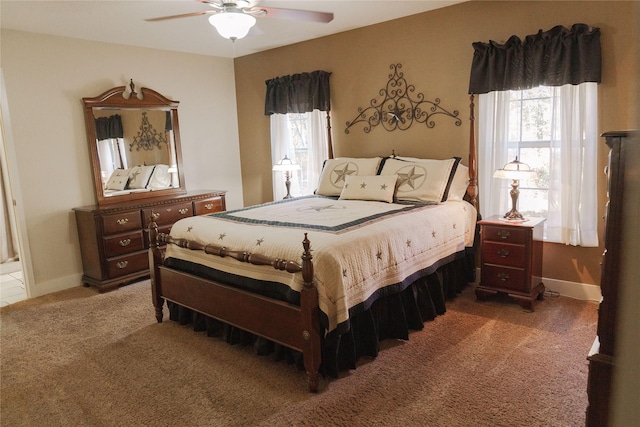 bedroom with carpet, ceiling fan, and multiple windows