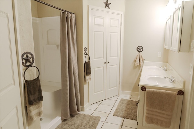 bathroom with a shower with shower curtain, tile patterned flooring, and vanity