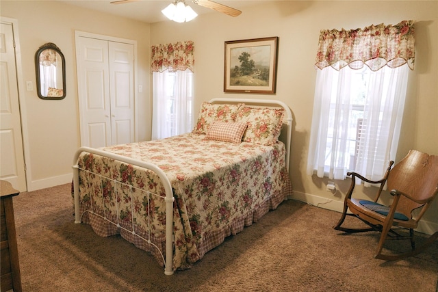 carpeted bedroom with ceiling fan and a closet