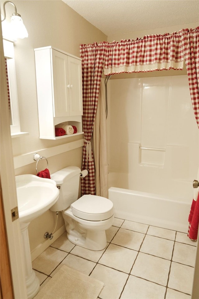 bathroom with toilet, shower / bath combo, and tile patterned floors